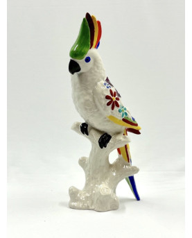The colored parrot made in porcelain by the masters of Capodimonte.